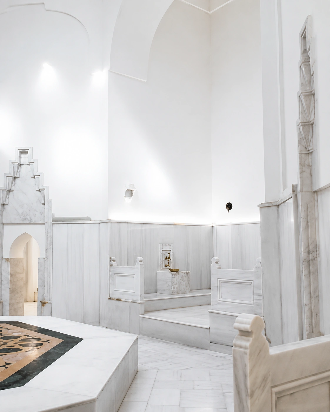 Steam-filled hot room of the Hurrem Sultan Hammam with marble basins along the walls