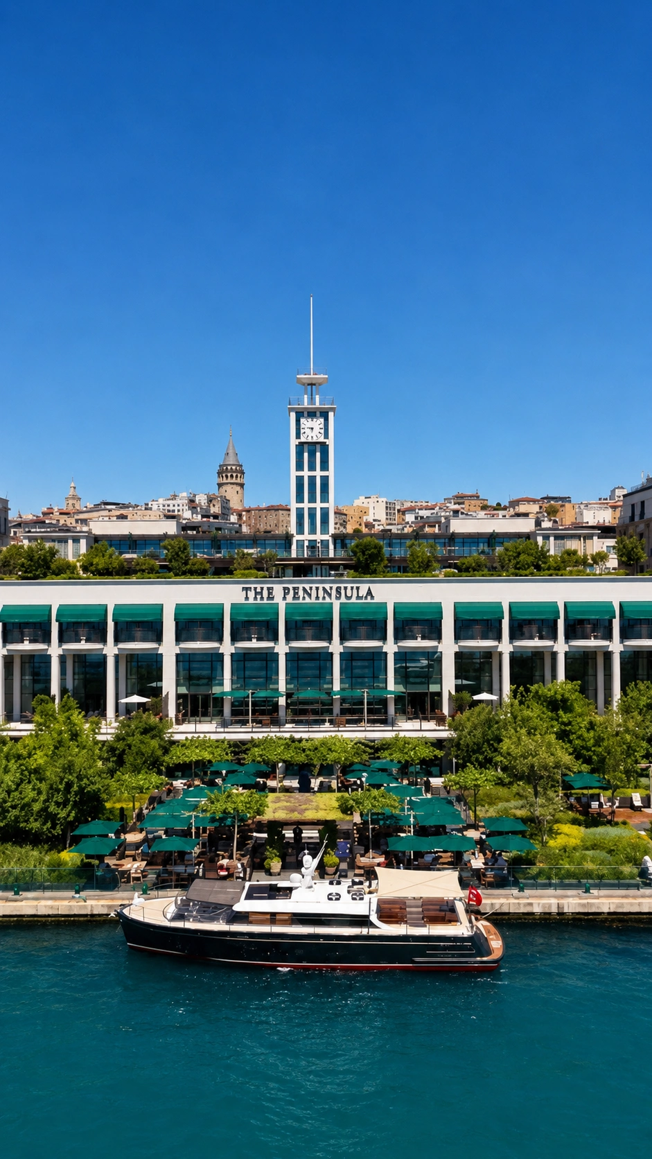 The Peninsula Istanbul waterfront with a boat passing on the Bosphorus