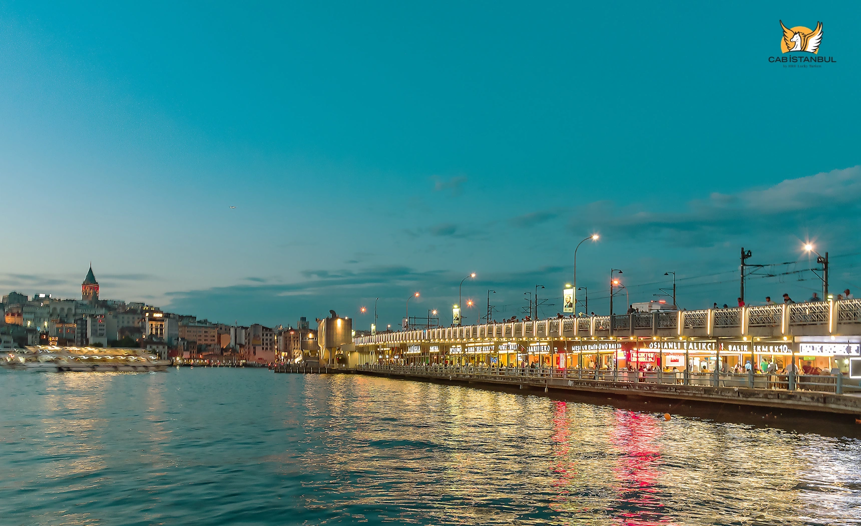 Tables and water views at dining spots under Galata Bridge